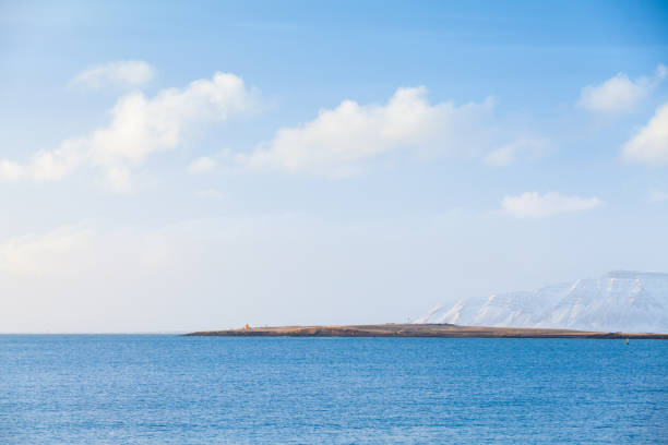 Icelandic coastal landscape. Snowy mountains under blue sky at winter day. Reykjavik, Iceland