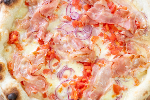 istock Close-up of baked pizza with bacon and mozzarella cheese 1296273003