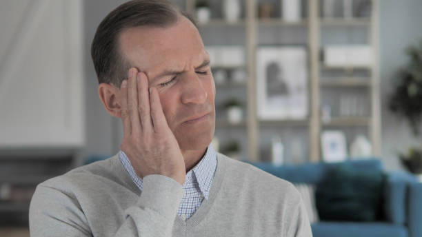 istock Portrait of Stressed Middle Aged Man with Headache 1296273169