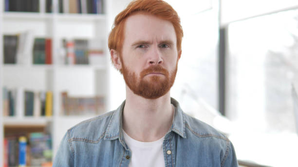 istock Young Casual Redhead Man Shaking Head to Reject 1296274141