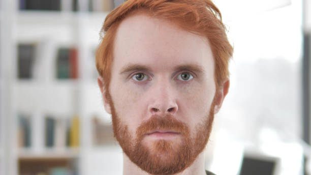 istock Face of Serious Young Casual Redhead Man 1296274736