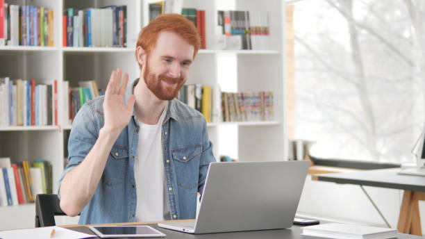 istock Online Video Chat on Laptop by Young Casual Redhead Man 1296274758