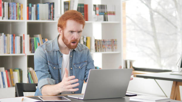 istock Loss, Frustrated Young Casual Redhead Man upset by Failure 1296274759