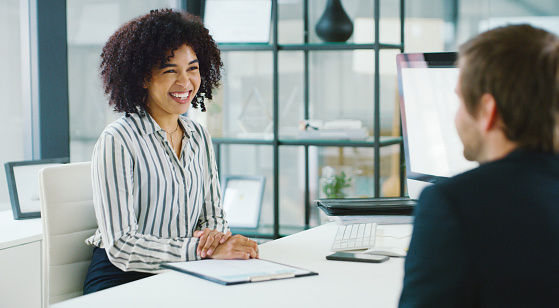 Shot of a young businessman and businesswoman having a discussion in an office