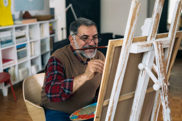 istock man painting picture at his home 1296276107