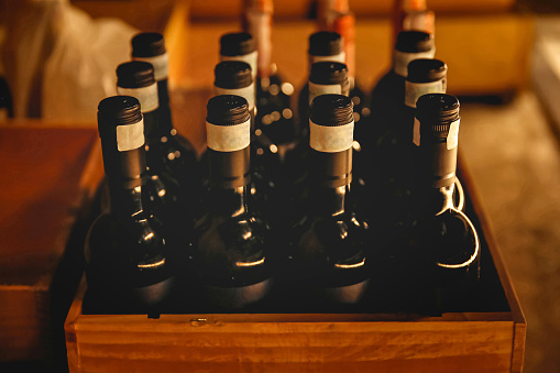 Close up shot of large group of wine bottle inside a wood case