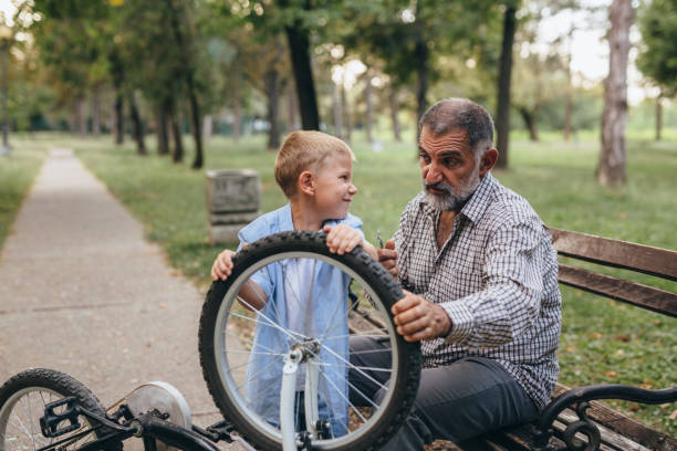 istock grandfather and grandson in public park 1296276421