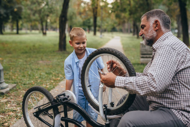 istock grandfather and grandson in public park 1296276422