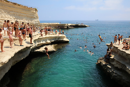 Marsaxlokk, Malta – August 13, 2019: St. Peter's Pool near Marsaxlokk. A very popular place for Locals and Tourists. Malta