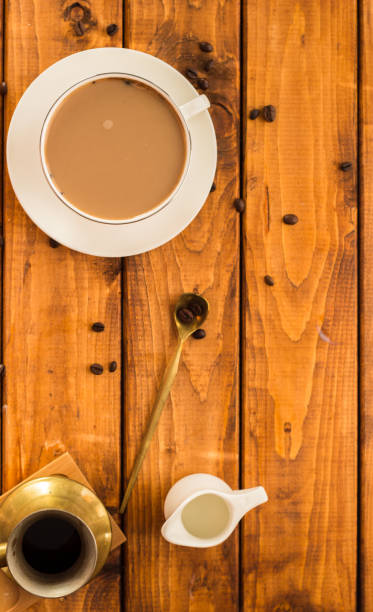 istock Cup of coffee with coffee beans on a beautiful brown background 1296277217
