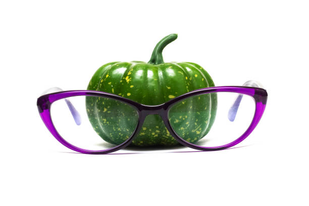 Little green pumpkin in glasses isolated on a white background