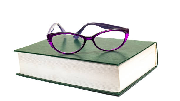 istock Glasses on a book isolated on white background 1296278998