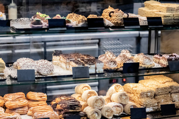 istock Different cakes on a glass shop window 1296279019