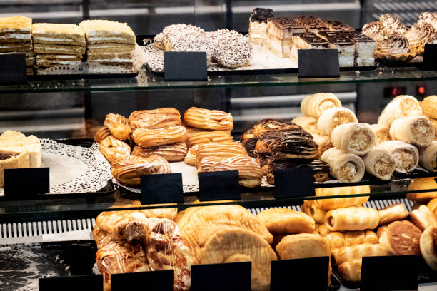istock Different cakes on a glass shop window 1296279025