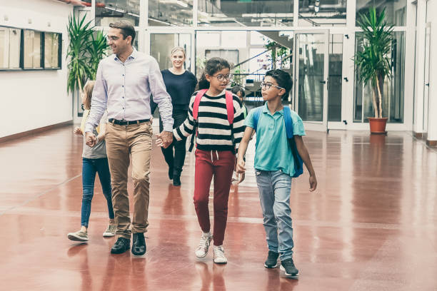 istock Mix raced group of classmates walking through hallway 1296285025