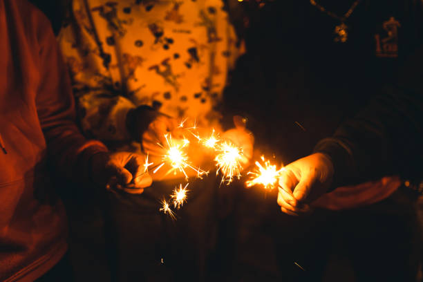 istock Celebrating a party with friends holding Sparklers. 1296285043