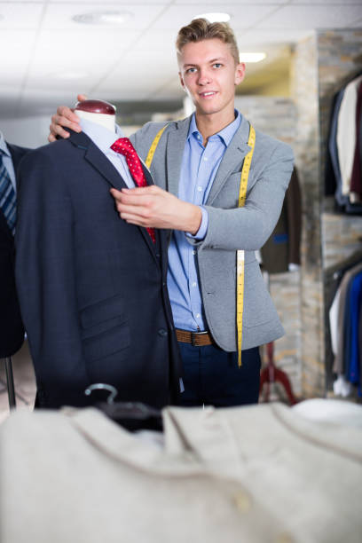 istock Seller in business clothes measuring jacket 1296285255