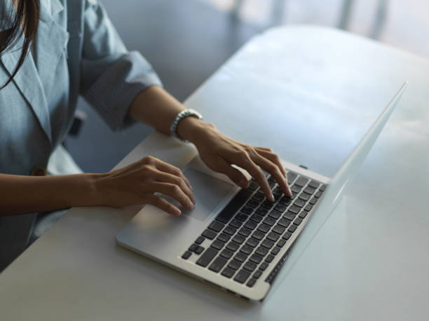 istock Female hands typing on laptop keyboard on the table 1296287090