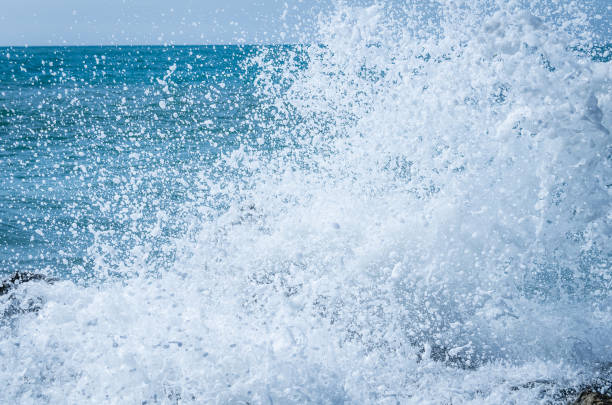 istock Crashing waves on the rocks 1296288806