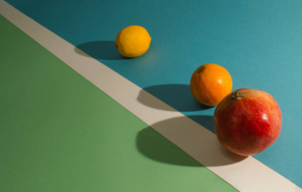istock Composition on playground with lemon, orange and pomegranate. Concept art. 1296292607