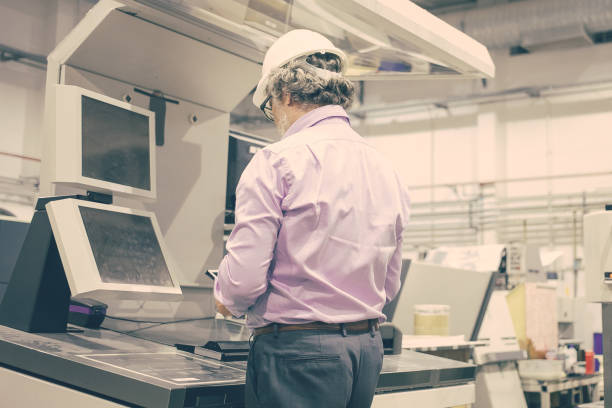 istock Grey haired male plant engineer in hardhat and glasses 1296292631