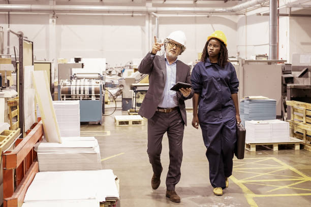 istock Mature male engineer and young black female technician 1296293930