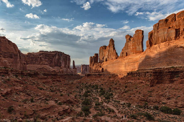 Adventures in desert of USA Southwest: Arches National Park at sunset People hiking in Arches National Park escalante stock pictures, royalty-free photos & images