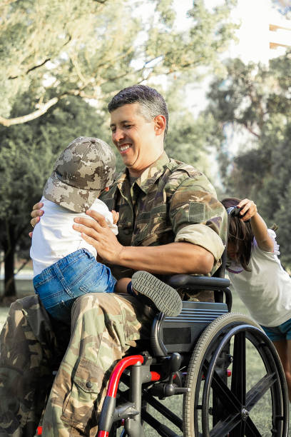 istock Joyful disabled military dad walking with two children 1296297234
