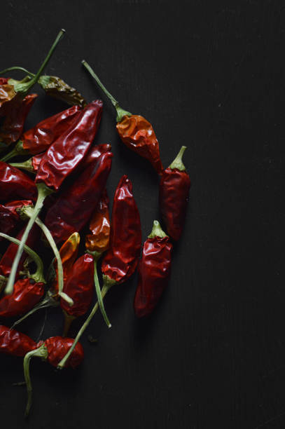 istock Dry red hot chili pepper on black background 1296297966