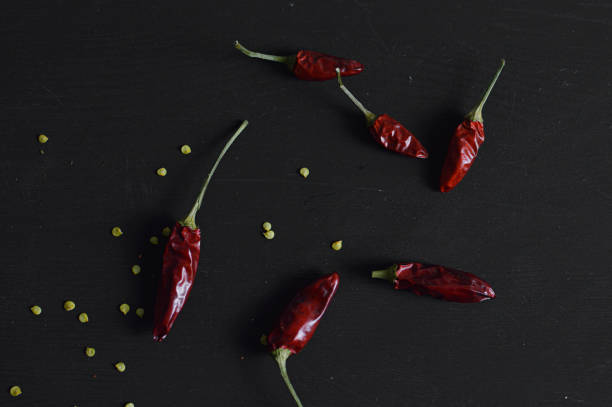 istock Dry red hot chili pepper on black background 1296298026