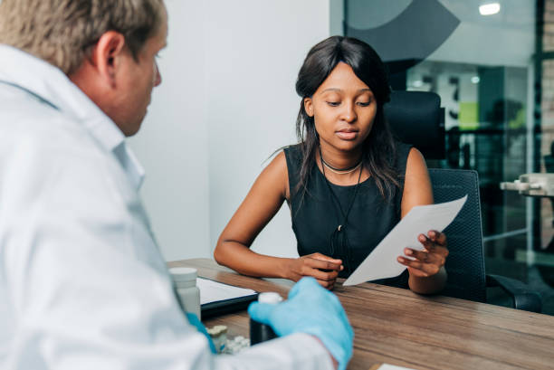 istock Woman reading prescription in doctor's office 1296298150