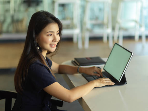 istock Female office worker working with laptop on the table in office room 1296298261