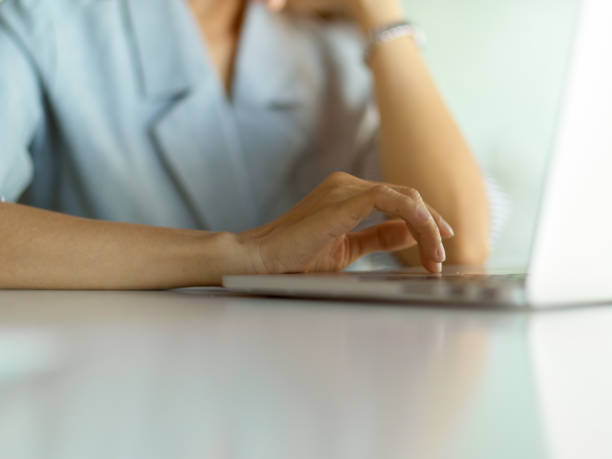 istock Businesswoman hand typing on laptop keyboard on white table 1296298939