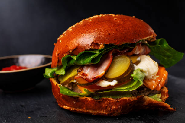 istock Fresh tasty burger  on dark background 1296300117