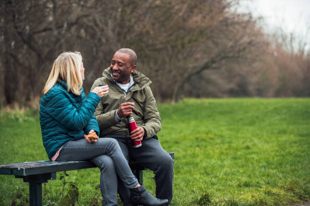 istock Senior Couple Picnic in their Public Park 1296302158