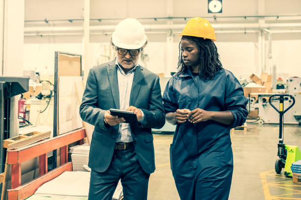 istock Caucasian manager discussing factory work with African worker 1296303151