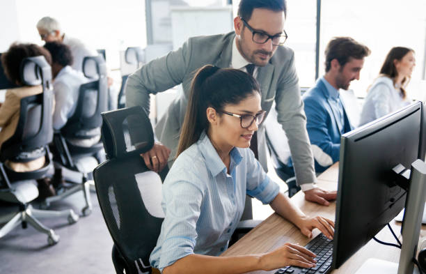 istock Group of young business people working and communicating at the office 1296303325