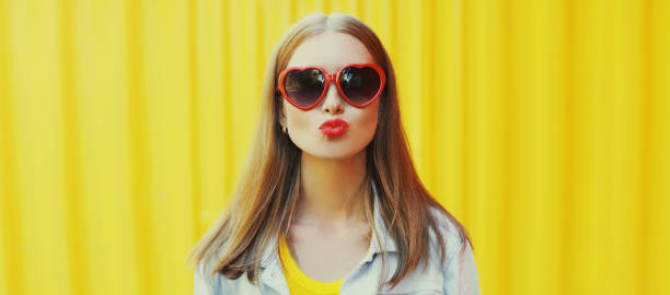 istock Cool girl model posing on yellow background 1296304275