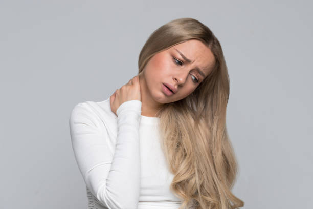 istock woman with pain in her neck and back. Cervical arthritis, osteochondrosis, overwork 1296308983
