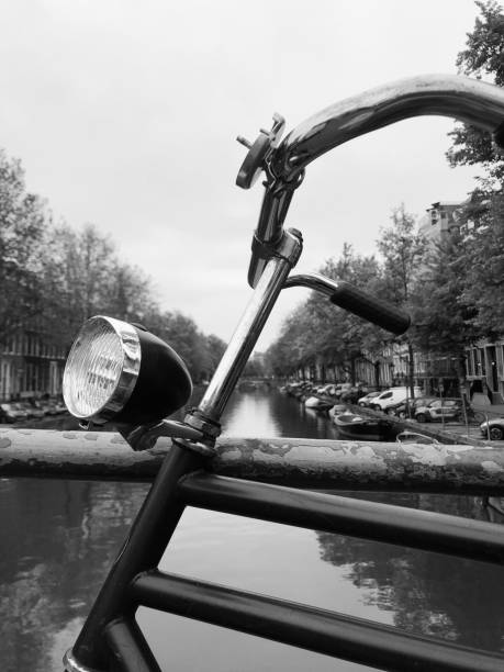 Strasbourg: Woman commuting on bike in French city at night - black and white image