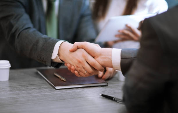 istock close up. business handshake at the negotiating table 1296310476