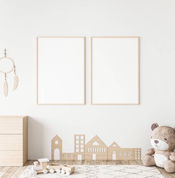 Mockup frame in minimal unisex child bedroom with natural wooden furniture stock photo