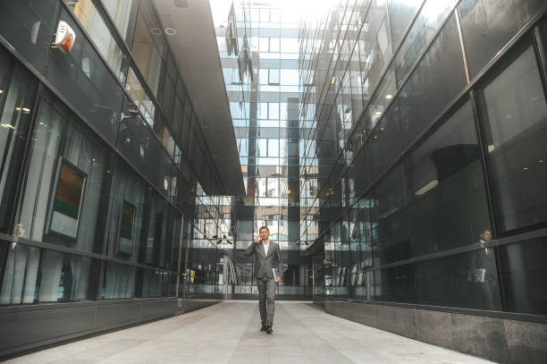 istock Businessman using phone, rushing to a meeting 1296311548