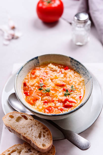 istock Vegetarian spicy tomato rice soup on grey concrete background 1296311976