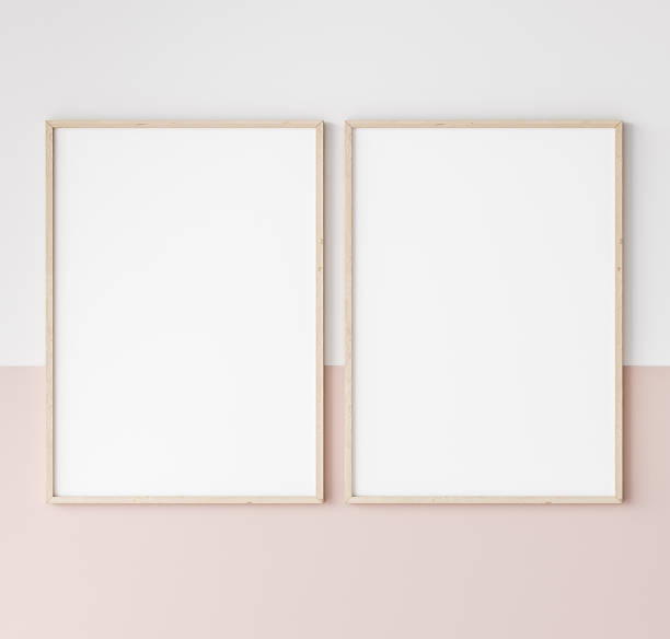 two wooden frames on pink and white wall, frame mockup stock photo