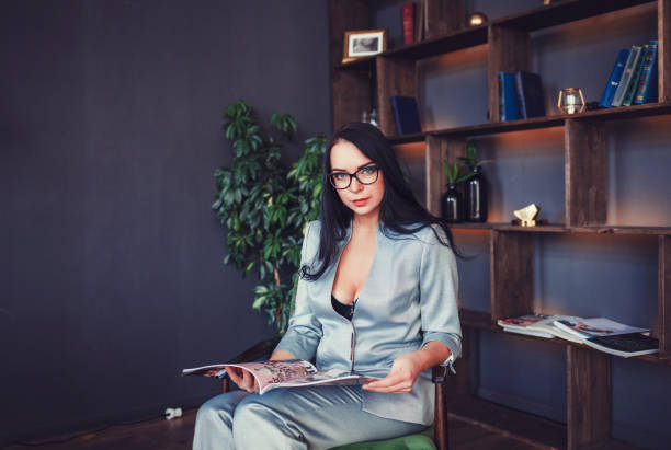 istock woman sitting with magazine 1296313192