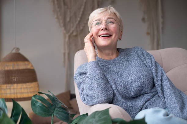 istock Senior woman smiling talking on phone at home 1296313224