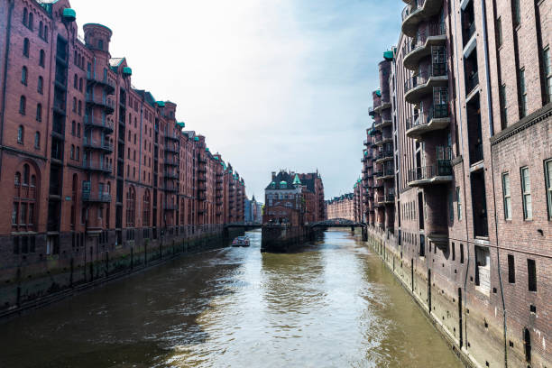 istock Old warehouses next to a canal in HafenCity, Hamburg, Germany 1296314509