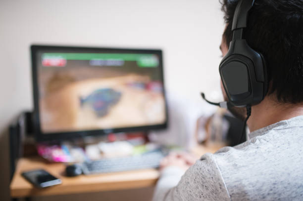 istock Young man with headphones playing a video game 1296315117