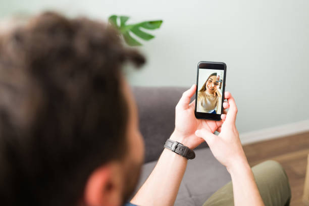 istock Husband is video chatting with his happy wife 1296316218